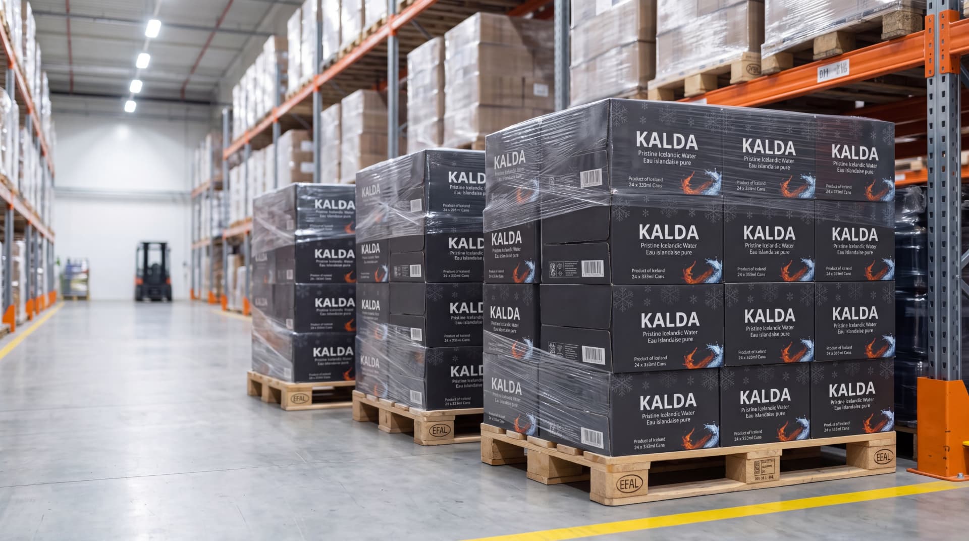 Pallets of KALDÁ cases shrink-wrapped and staged in a distribution warehouse