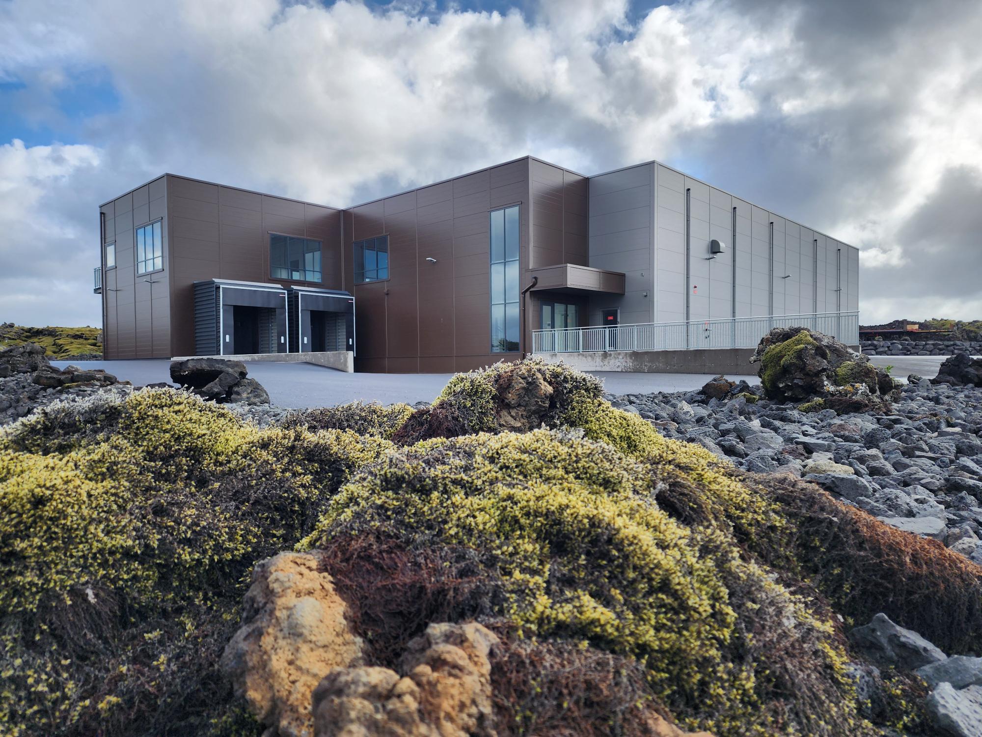 The Pure Water facility in Hafnarfjörður, set in mossed lava field under arctic sky